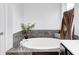Soaking tub with tile surround and decorative accents provides a relaxing retreat at 749 Bracknell Dr, Avon, IN 46123