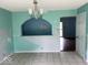 Dining room featuring a chandelier, tile flooring, and an open view into the living room at 8045 Briarwood Dr, Indianapolis, IN 46227