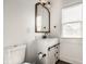 Stylish bathroom featuring a vanity with sliding doors, a mirror, and a toilet at 805 N Temple Ave, Indianapolis, IN 46201