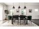 Bright dining room with modern light fixtures, table, and plush chairs near two large windows at 805 N Temple Ave, Indianapolis, IN 46201