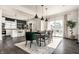 Elegant dining area with a modern table, stylish chairs, and natural light pouring in from a sliding glass door at 805 N Temple Ave, Indianapolis, IN 46201