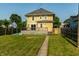 Charming yellow two-story home with deck at 805 N Temple Ave, Indianapolis, IN 46201
