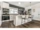 Modern kitchen with stainless steel appliances, subway tile backsplash, island with seating, and wood floors at 805 N Temple Ave, Indianapolis, IN 46201