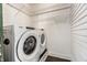 Efficient laundry area with modern washer and dryer, plus shelving for organized storage solutions at 805 N Temple Ave, Indianapolis, IN 46201