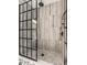 Modern shower featuring decorative tile, glass enclosure, and rainfall showerhead at 805 N Temple Ave, Indianapolis, IN 46201