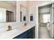 Modern bathroom featuring a dual sink vanity with gold fixtures and a view into an adjacent bedroom at 8263 Bryce Blvd, Pendleton, IN 46064
