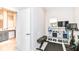 Home gym with weights, bench, bike, TV, and mirror, located off the main bath at 8263 Bryce Blvd, Pendleton, IN 46064