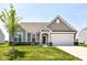 Charming home with a well-manicured lawn, gray siding, and a two-car garage at 8263 Bryce Blvd, Pendleton, IN 46064