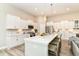 Spacious kitchen features white cabinets, long island with seating, and stainless steel appliances at 8263 Bryce Blvd, Pendleton, IN 46064