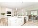 Spacious kitchen view with island, sink, stainless appliances, and view into living and dining areas at 8263 Bryce Blvd, Pendleton, IN 46064