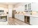 Bright kitchen featuring white cabinets, herringbone backsplash, stainless steel appliances, and wine fridge at 8263 Bryce Blvd, Pendleton, IN 46064