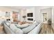 Bright living room features modern fireplace, large sectional, and beautiful wood floors at 8263 Bryce Blvd, Pendleton, IN 46064
