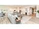 Spacious living room with neutral tones, flows into the kitchen with white cabinets at 8263 Bryce Blvd, Pendleton, IN 46064