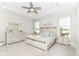 Serene main bedroom features a tray ceiling, neutral color scheme, and scenic lake views at 8263 Bryce Blvd, Pendleton, IN 46064