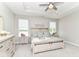 Serene main bedroom boasts a decorative tray ceiling, neutral colors, and view of the lake at 8263 Bryce Blvd, Pendleton, IN 46064