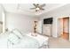 Bright main bedroom featuring a tray ceiling, ceiling fan, and ensuite bathroom access at 8263 Bryce Blvd, Pendleton, IN 46064