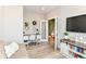 Well-lit home office featuring desk, chair, television, and barn door cabinet at 8263 Bryce Blvd, Pendleton, IN 46064