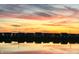 Scenic view of homes by the pond at sunset, with a colorful sky and reflections mirrored in the water at 8263 Bryce Blvd, Pendleton, IN 46064