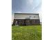 Exterior of home with a brick base and vinyl siding visible from the backyard at 832 Spinney Ln, Whiteland, IN 46184