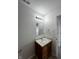 Nicely lit bathroom with a wooden vanity and sink area and updated lighting at 832 Spinney Ln, Whiteland, IN 46184
