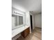 Bathroom with updated vanity, lighting, hardwood floors, with a peek into the shower/tub at 832 Spinney Ln, Whiteland, IN 46184