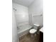 Bathroom with shower-tub combo and white shower surround at 832 Spinney Ln, Whiteland, IN 46184