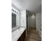 Bathroom featuring an updated vanity, large mirror, and access to the shower and tub at 832 Spinney Ln, Whiteland, IN 46184