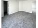 Large carpeted bedroom with neutral colors and doorways visible at 832 Spinney Ln, Whiteland, IN 46184