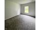 Bedroom features soft, neutral carpeting, and a large window at 832 Spinney Ln, Whiteland, IN 46184