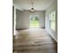 Bright dining room with wood-look floors, slider to backyard and modern light fixture at 832 Spinney Ln, Whiteland, IN 46184