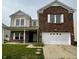 Charming two-story brick home featuring a covered front porch and a two-car garage at 832 Spinney Ln, Whiteland, IN 46184