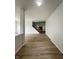 Spacious hallway with hardwood floors leading to a staircase and living areas at 832 Spinney Ln, Whiteland, IN 46184