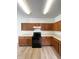 Updated kitchen featuring wood cabinets, modern black appliances, and ample countertop space at 832 Spinney Ln, Whiteland, IN 46184