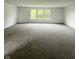 Bright living room featuring neutral carpet, large windows and freshly painted white walls at 832 Spinney Ln, Whiteland, IN 46184