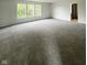 Spacious living room with plush carpeting and bright windows at 832 Spinney Ln, Whiteland, IN 46184