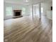 Open-concept living room featuring a fireplace, hardwood floors, and ample space for entertaining at 832 Spinney Ln, Whiteland, IN 46184