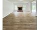 Open-concept living room with a stone fireplace, hardwood floors, and access to a sliding glass door at 832 Spinney Ln, Whiteland, IN 46184