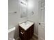 Bathroom vanity featuring wood cabinet, laminate countertop, and square mirror at 832 Spinney Ln, Whiteland, IN 46184