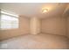 Spacious carpeted basement with painted brick walls and a large window, offering natural light at 8410 Hague Rd # 5, Indianapolis, IN 46256