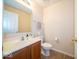 A half bath featuring laminate floors, updated vanity, toilet and modern fixtures at 8410 Hague Rd # 5, Indianapolis, IN 46256
