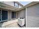 Townhouse entrance featuring two doors, neutral siding, small stone garden, and an air conditioning unit at 8410 Hague Rd # 5, Indianapolis, IN 46256