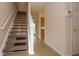 Inviting interior showcasing a staircase and hardwood flooring leading to the kitchen at 8410 Hague Rd # 5, Indianapolis, IN 46256
