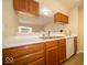 A quaint kitchen area featuring wood cabinets, white countertops, and an eat-in breakfast bar at 8410 Hague Rd # 5, Indianapolis, IN 46256