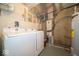 Functional laundry room with a washer and dryer, complimented by utility shelving for storage at 8410 Hague Rd # 5, Indianapolis, IN 46256