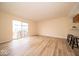 Open-concept living area featuring wood-look floors, natural light, and a sliding glass door to the yard at 8410 Hague Rd # 5, Indianapolis, IN 46256