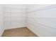 Walk-in pantry with white wire shelving for ample storage space and wood-look floors at 864 Cowley Dr, Westfield, IN 46074