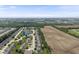 A picturesque aerial view shows the property's neighborhood and the surrounding landscape with open fields at 10934 Harness Ct, Indianapolis, IN 46239
