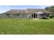 A well-maintained backyard with a patio, white fence, and lush green grass offers a tranquil outdoor space at 10934 Harness Ct, Indianapolis, IN 46239
