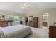 Large primary bedroom featuring plush carpet and an ensuite bathroom and walk-in closet at 10934 Harness Ct, Indianapolis, IN 46239