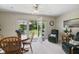 Bright dining area featuring a wooden table, chairs, and a view of the backyard patio at 10934 Harness Ct, Indianapolis, IN 46239